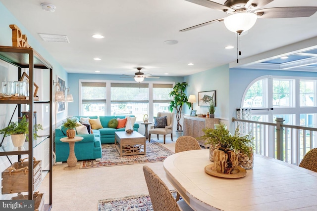 dining area featuring light colored carpet and ceiling fan