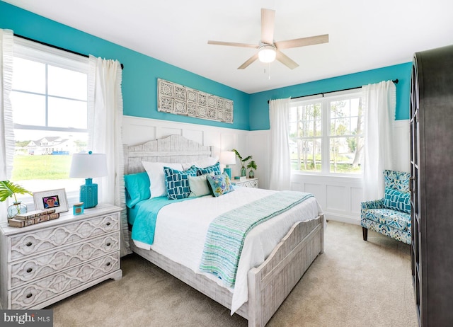 bedroom with light carpet and ceiling fan