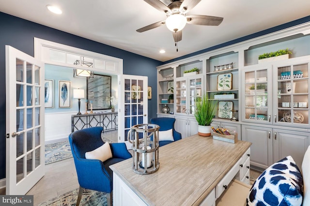 office area featuring french doors, ceiling fan, and light wood-type flooring