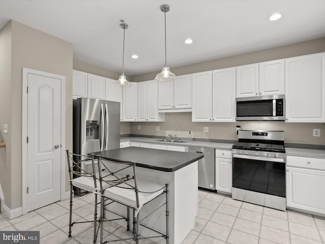 kitchen with white cabinetry, sink, decorative light fixtures, and appliances with stainless steel finishes