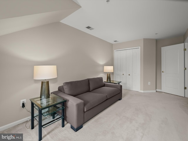 carpeted living room featuring lofted ceiling