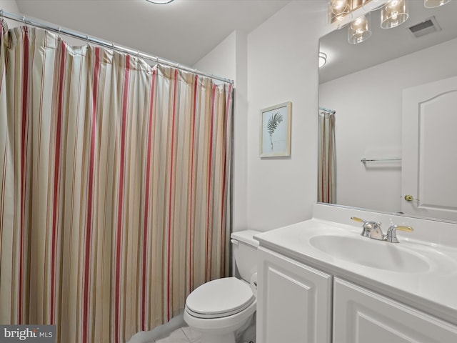 bathroom with a shower with curtain, vanity, toilet, and tile patterned flooring