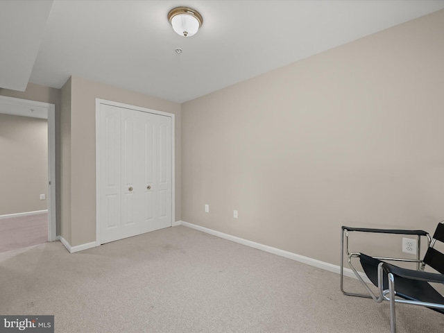 sitting room featuring light carpet