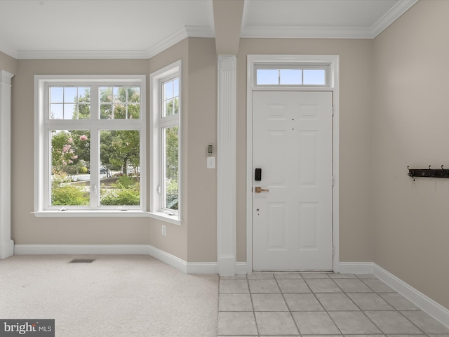 foyer entrance with crown molding and light colored carpet