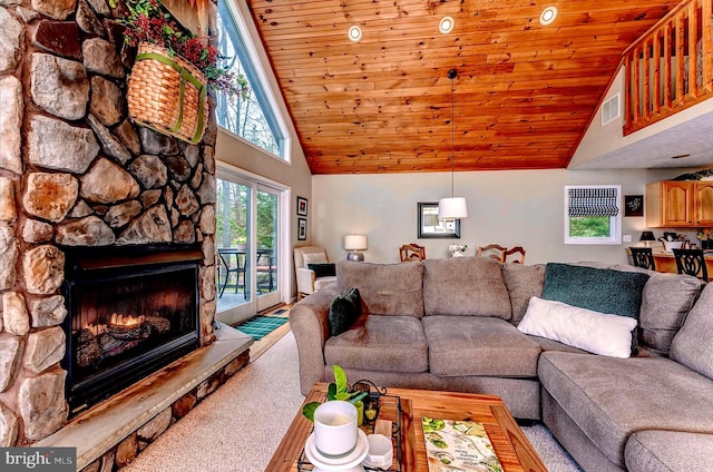 carpeted living room with wooden ceiling, high vaulted ceiling, and a stone fireplace