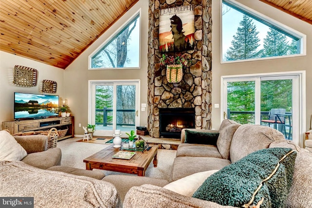 carpeted living room featuring wood ceiling, a fireplace, and high vaulted ceiling