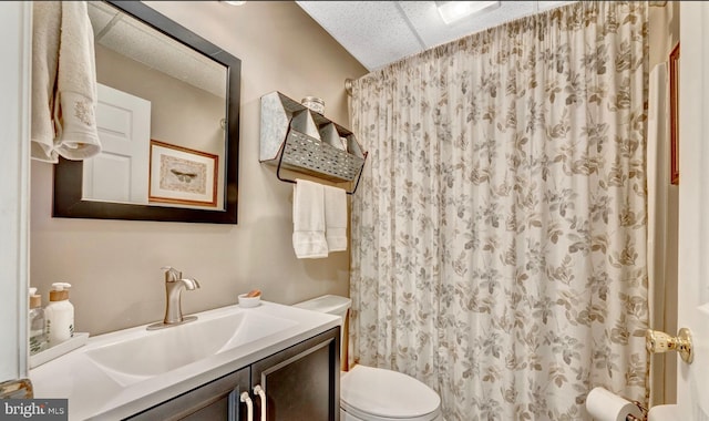 bathroom featuring toilet and large vanity