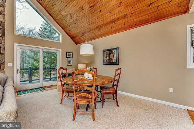 carpeted dining space featuring high vaulted ceiling and wood ceiling