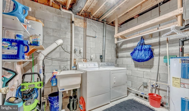 washroom featuring gas water heater, sink, hookup for an electric dryer, and washer and clothes dryer