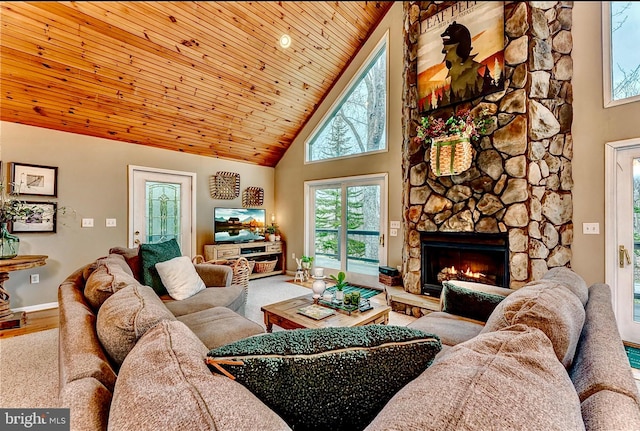 living room with high vaulted ceiling, light hardwood / wood-style flooring, wood ceiling, and a stone fireplace