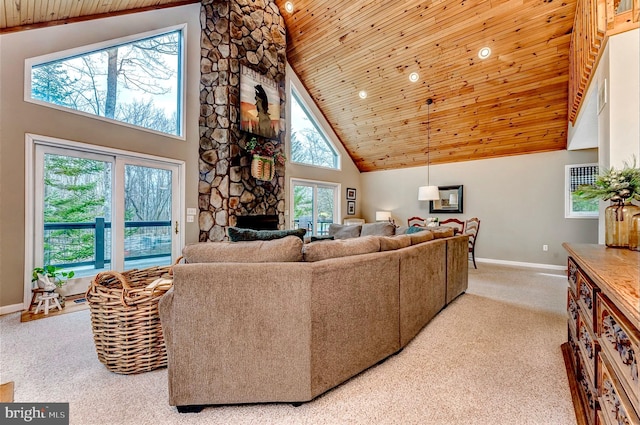 carpeted living room featuring a fireplace, high vaulted ceiling, and wooden ceiling