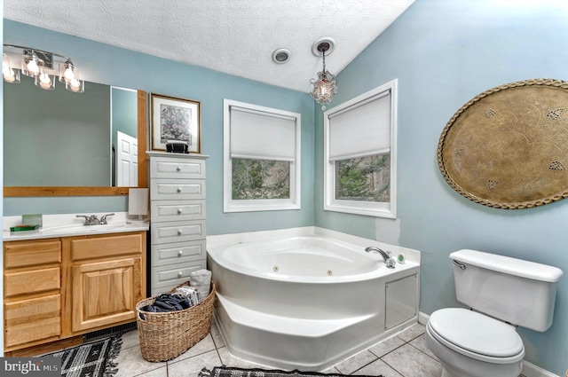 bathroom featuring tile floors, a textured ceiling, toilet, a bathtub, and oversized vanity