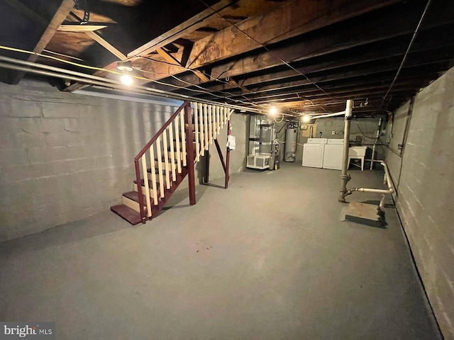 basement featuring water heater and independent washer and dryer