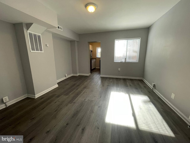 unfurnished room featuring dark hardwood / wood-style flooring