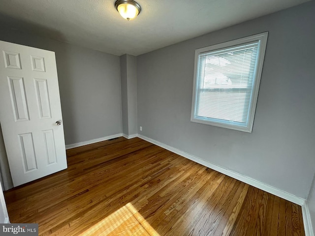 spare room featuring hardwood / wood-style floors