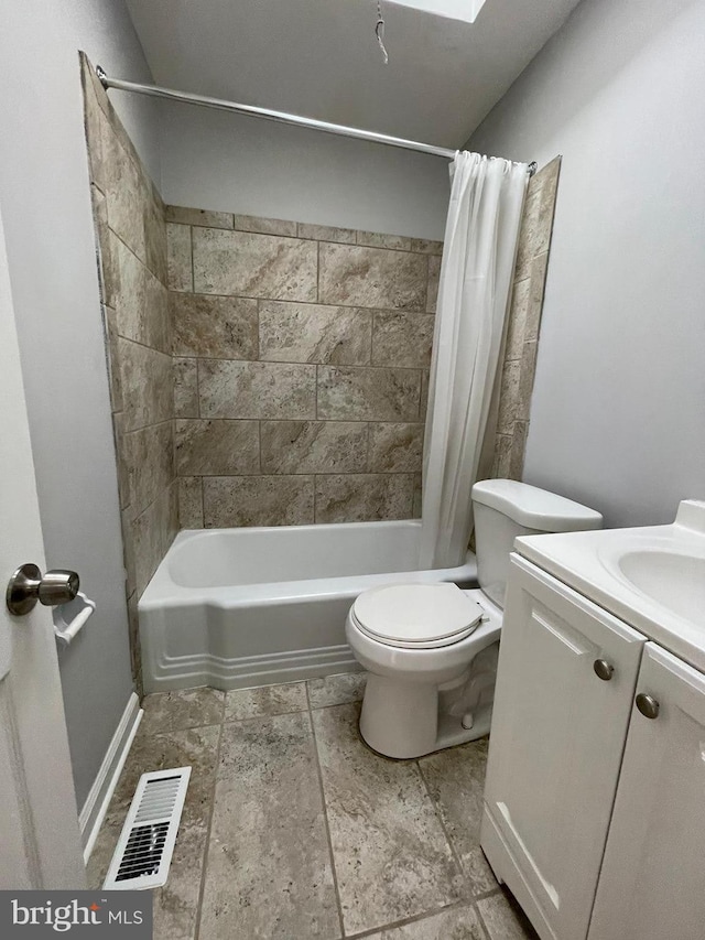 full bathroom with shower / bath combination with curtain, tile floors, toilet, and vanity