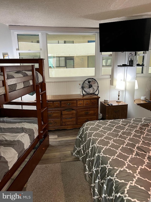 bedroom featuring dark wood-type flooring and a textured ceiling