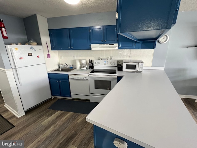 kitchen featuring white appliances, blue cabinets, sink, dark wood-type flooring, and a textured ceiling