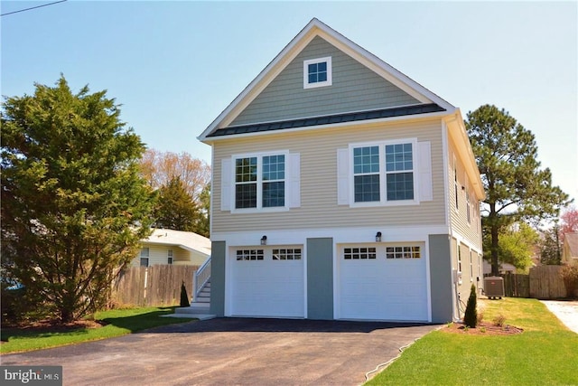 view of front of home featuring central AC and a garage