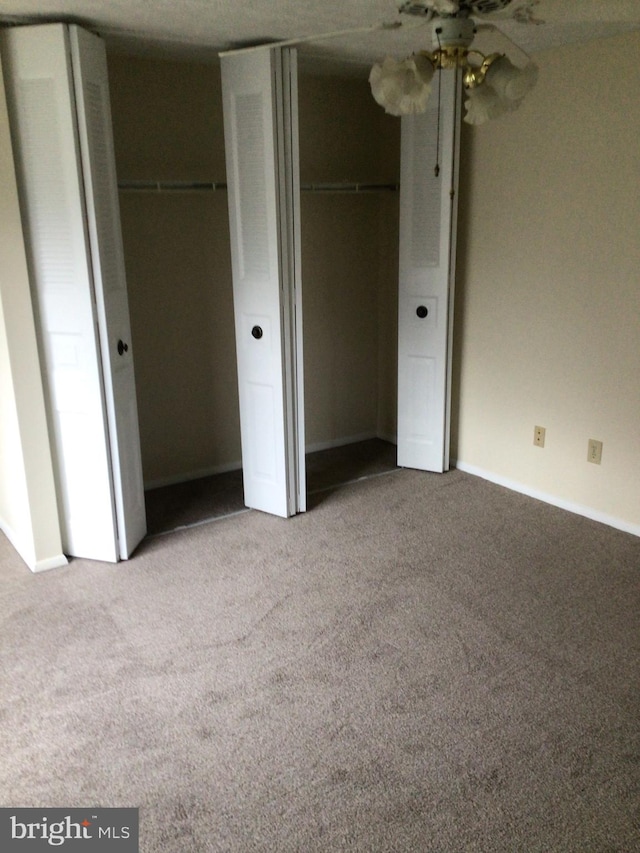 unfurnished bedroom featuring ceiling fan and light colored carpet