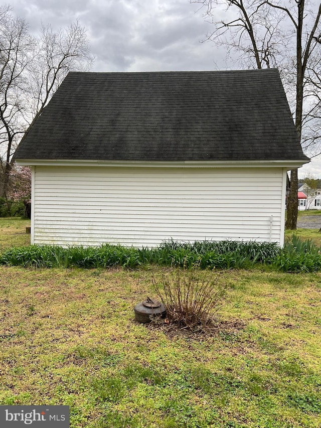 view of side of home with a yard