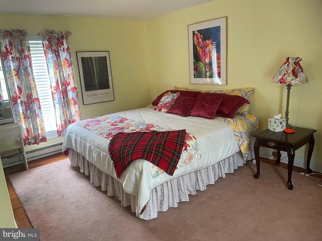 bedroom featuring a baseboard radiator and light colored carpet