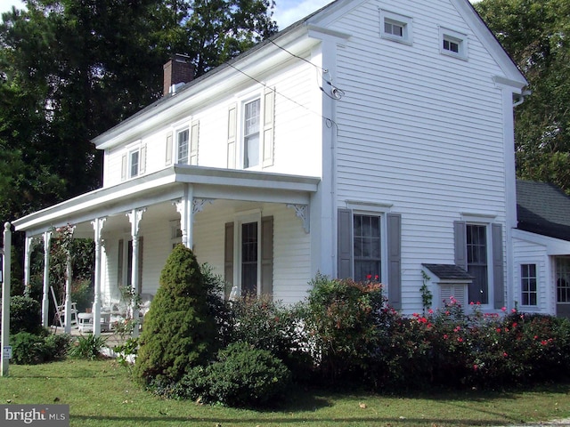 view of home's exterior featuring a yard and covered porch