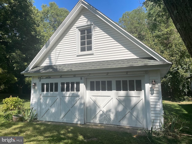 garage featuring a lawn