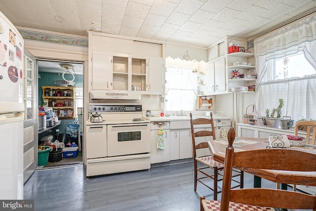 kitchen featuring white cabinetry, double oven range, dark hardwood / wood-style floors, and sink