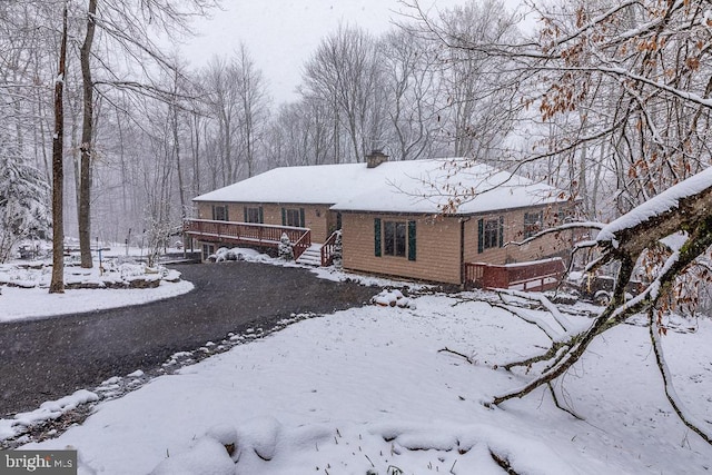 single story home with a wooden deck