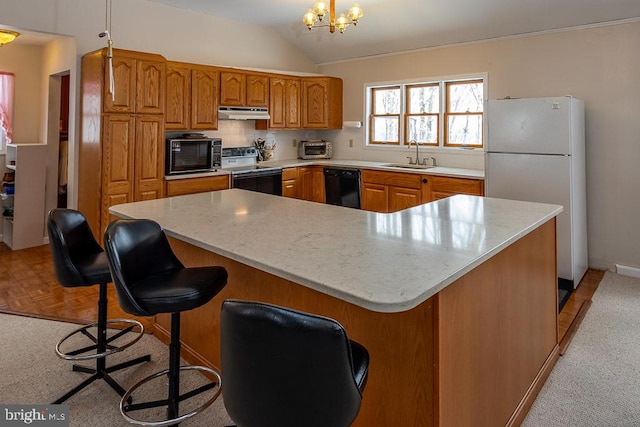 kitchen with hanging light fixtures, an inviting chandelier, vaulted ceiling, black appliances, and sink