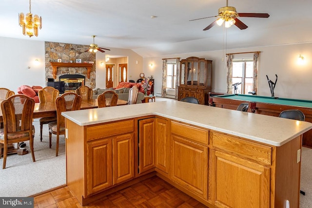 kitchen featuring a kitchen island, pool table, a fireplace, and hanging light fixtures