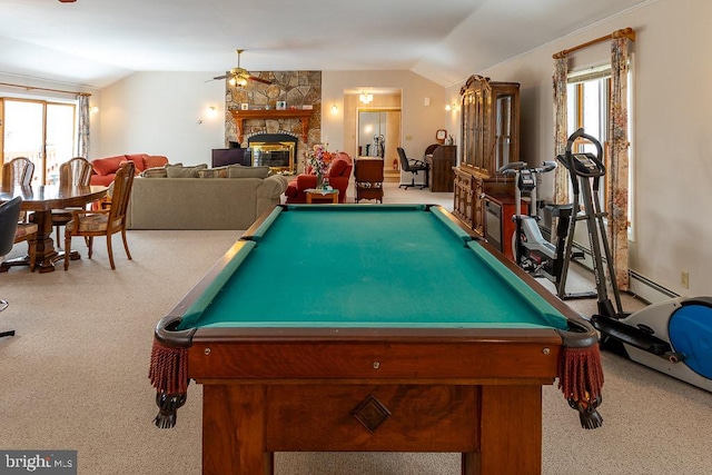 playroom with a fireplace, ceiling fan, vaulted ceiling, baseboard heating, and light colored carpet