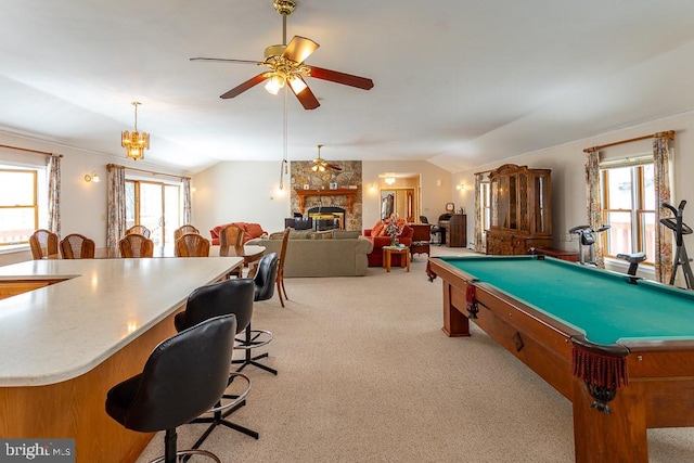 recreation room featuring light colored carpet, lofted ceiling, a wealth of natural light, and a fireplace