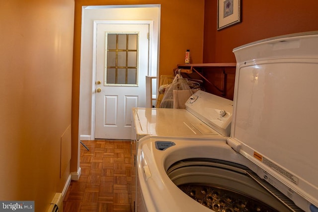 washroom with parquet floors and washing machine and clothes dryer