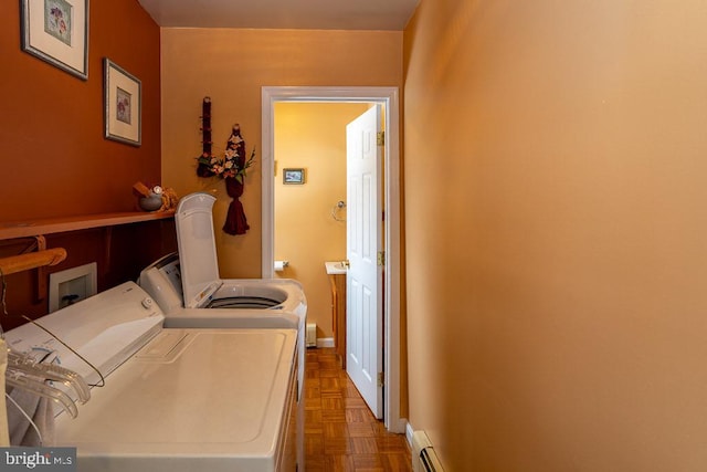 washroom with parquet flooring and independent washer and dryer