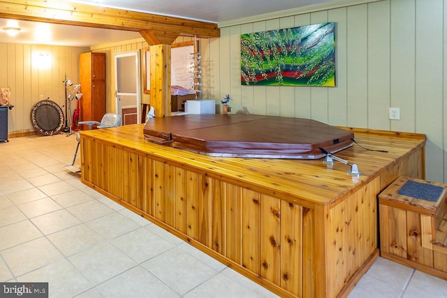 interior space with wooden walls and light tile patterned floors