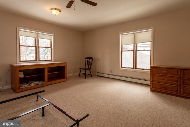 sitting room featuring ceiling fan, a baseboard heating unit, and light colored carpet