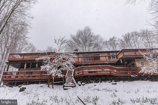 snow covered property featuring a deck