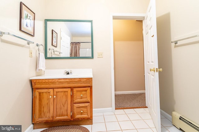 bathroom featuring vanity, baseboard heating, and tile patterned flooring