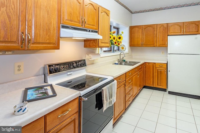 kitchen featuring white appliances, light tile patterned floors, and sink