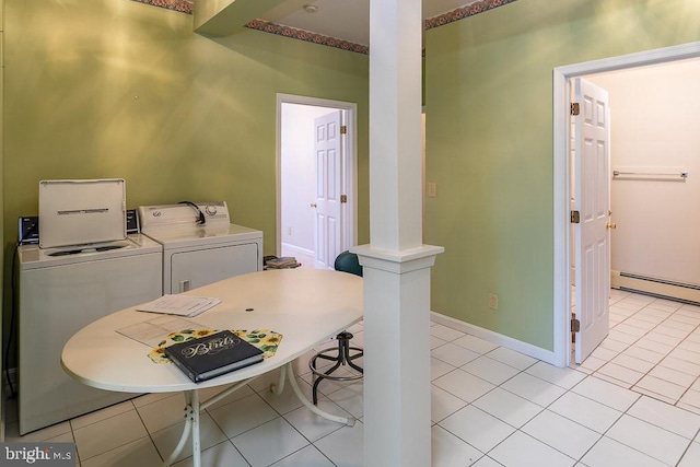 laundry area with a baseboard radiator, washer and dryer, and light tile patterned floors