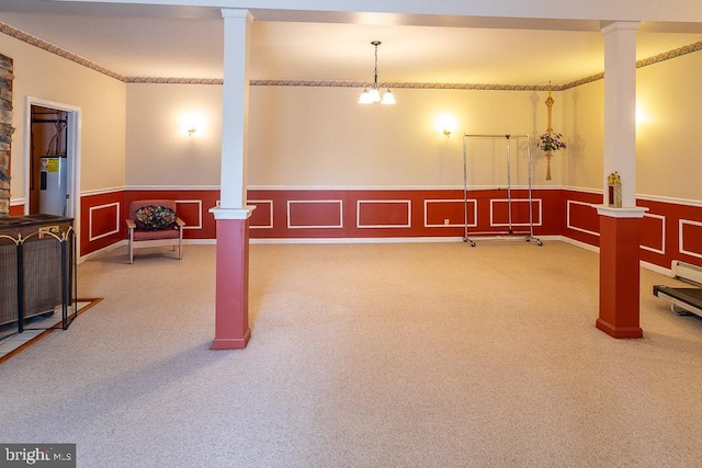 basement featuring crown molding, carpet, and a chandelier