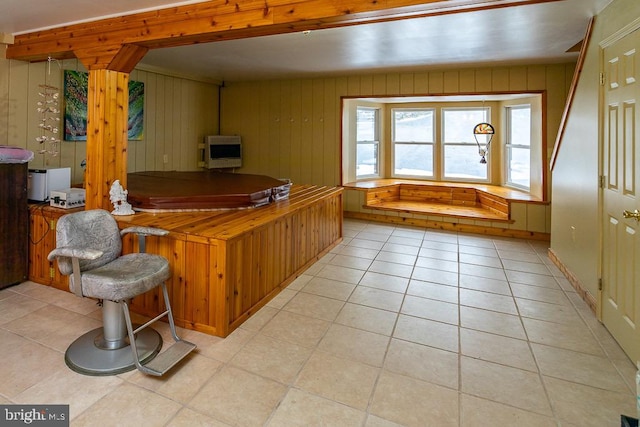 bar with light tile patterned floors, wood walls, and heating unit