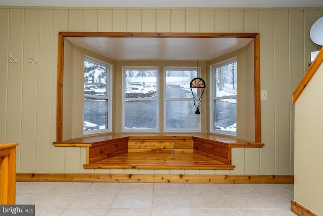 details with wood walls and tile patterned floors