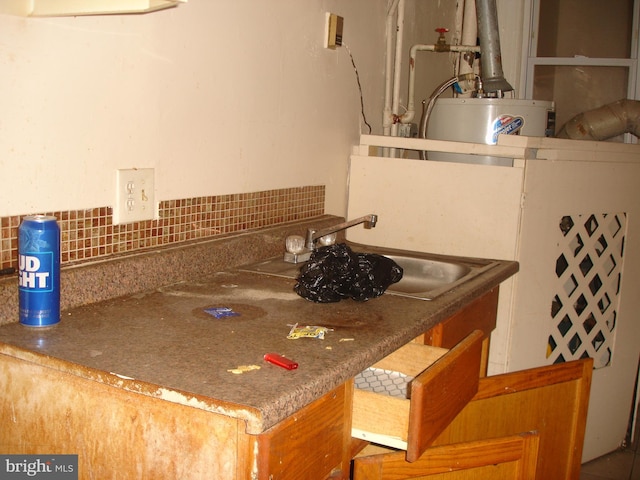 kitchen featuring water heater, sink, and tasteful backsplash