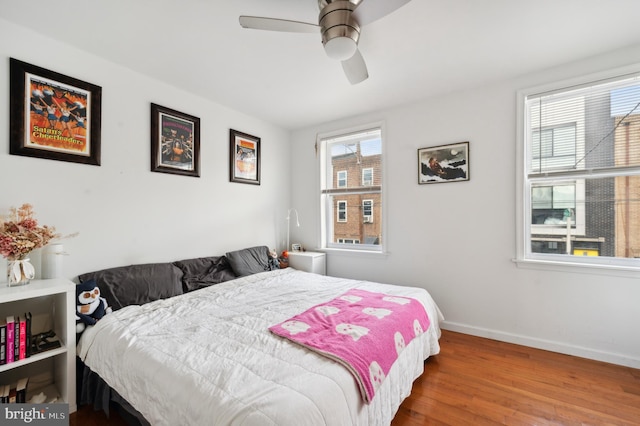 bedroom with wood-type flooring and ceiling fan