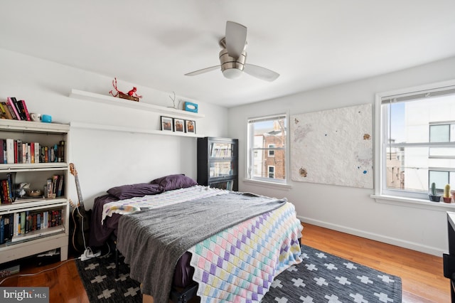 bedroom with ceiling fan and hardwood / wood-style flooring