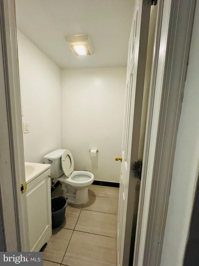 bathroom featuring tile floors, toilet, and vanity