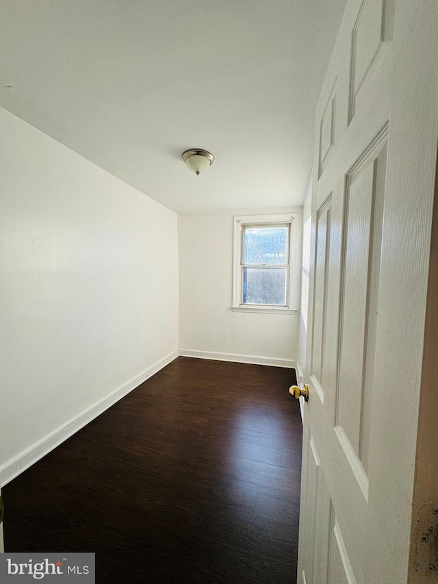 spare room featuring dark hardwood / wood-style floors